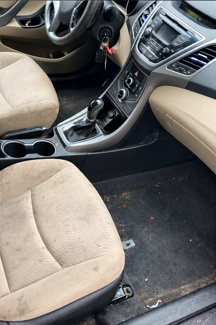 Vehicle interior before detailing by Geoffrey’s Mobile Auto Detailing
